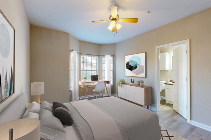 A comfortable bedroom in Reflections on Sweetwater, featuring modern furnishings, a cozy bed, and stylish decor.
